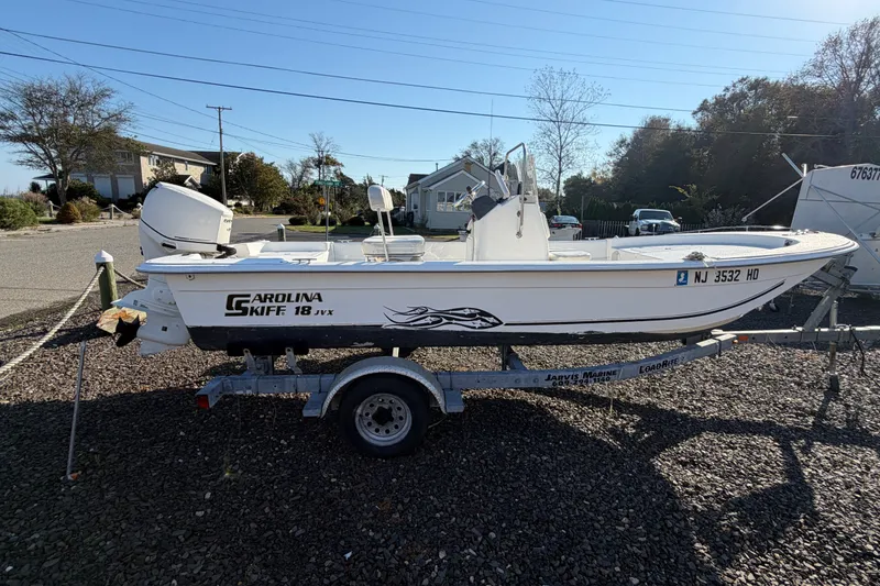 The Image of 2011 Carolina Skiff 18 JVX CC boat on trailer, parked outdoors. - 0