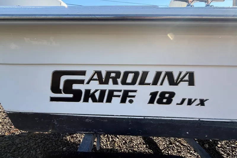 Slide: The Image of 2011 Carolina Skiff 18 JVX CC boat logo on white hull. - 14