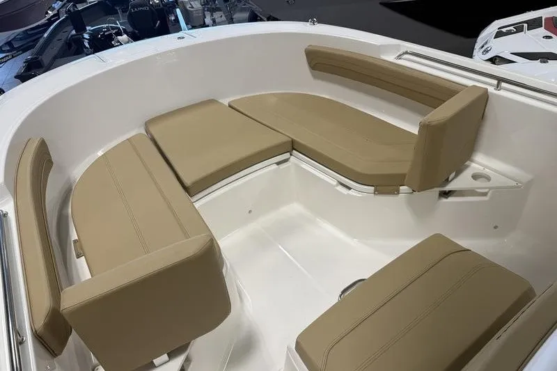 Slide: The Image of 2025 Bayliner Trophy T24CC boat interior with tan cushioned seating. - 15