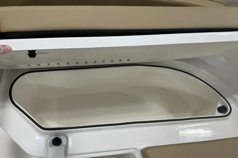 Slide: The Image of 2025 Bayliner Trophy T24CC storage compartment with beige seating. - 19
