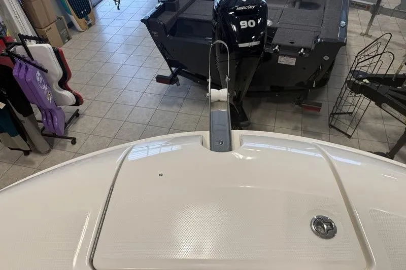 Slide: The Image of 2025 Bayliner Trophy T24CC boat with Mercury 90 outboard motor in showroom. - 21