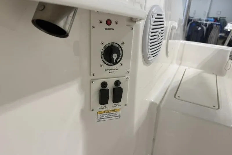 Slide: The Image of 2025 Bayliner Trophy T24CC boat control panel with battery switch and speaker. - 24