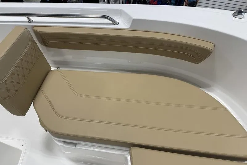 Slide: The Image of 2025 Bayliner Trophy T24CC boat interior with beige cushioned seating. - 18
