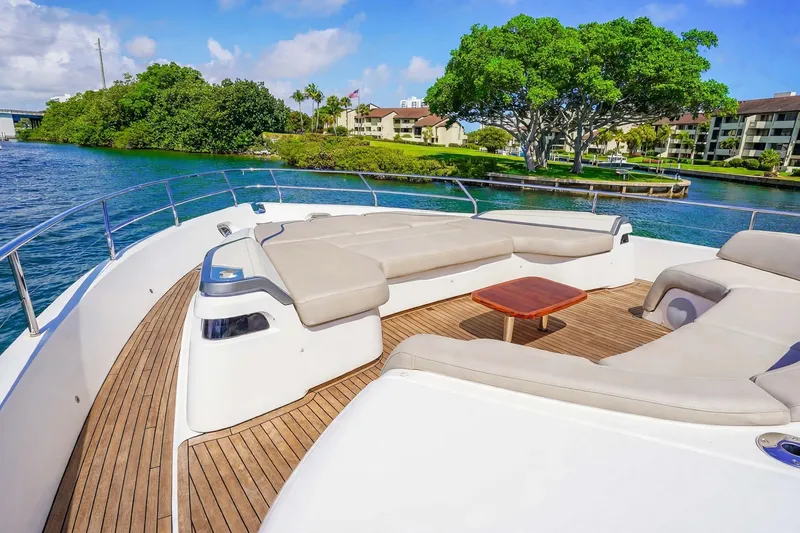 Slide: The Image of Luxurious 2021 Princess Y85 yacht deck with plush seating, overlooking serene waterfront scenery. - 13