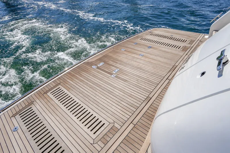 Slide: The Image of Luxury yacht Princess Y85 2021 teak deck with ocean waves in the background. - 10