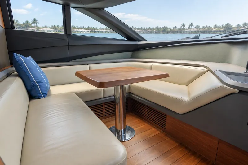 Slide: The Image of Intérieur d'un yacht de luxe avec un coin salon élégant et une table en bois, entouré de grandes fenêtres. - 41