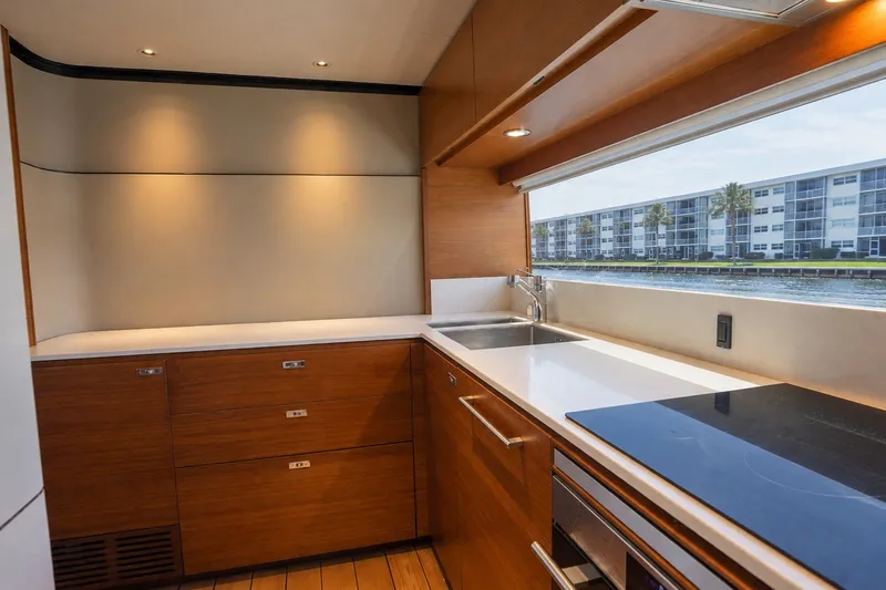 Slide: The Image of Modern kitchen interior on 2021 Princess Y85 yacht with sleek wood cabinetry and waterfront view. - 35
