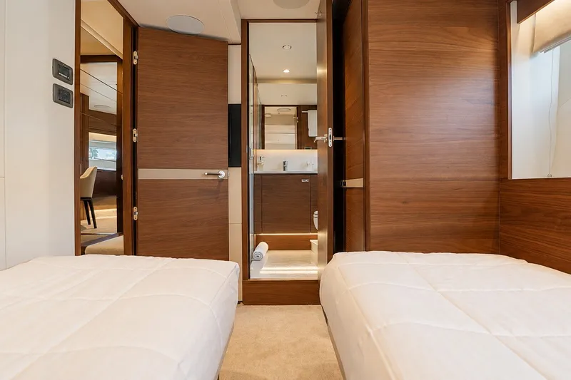 Slide: The Image of Luxurious interior of 2021 Princess Y85 yacht with twin beds and wooden finishes. - 59