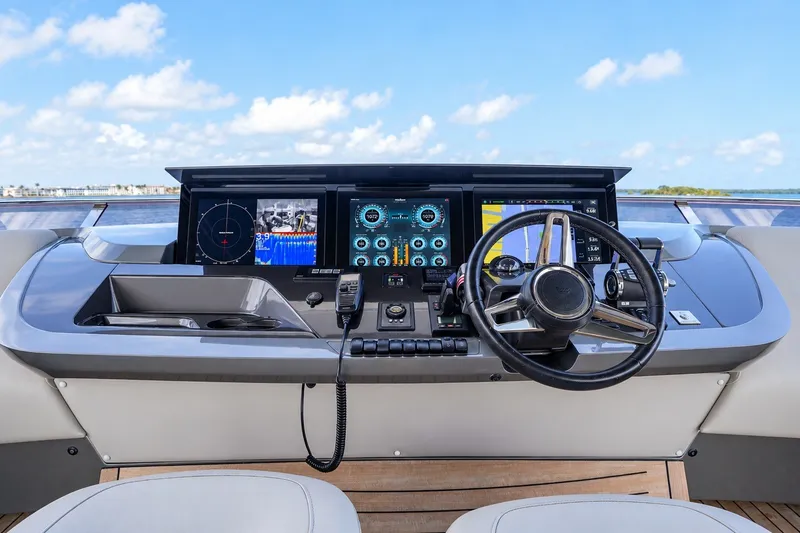 Slide: The Image of Helm of 2021 Princess Y85 yacht with advanced navigation displays and steering wheel. - 21