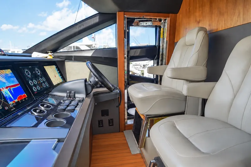 Slide: The Image of Luxurious 2021 Princess Y85 yacht cockpit with modern controls and plush seating. - 38