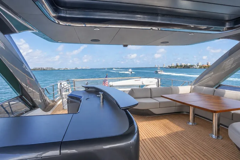Slide: The Image of Luxurious 2021 Princess Y85 yacht deck with seating, bar, and ocean view. - 16