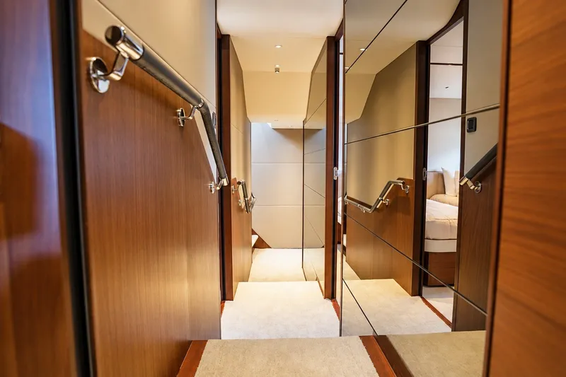 Slide: The Image of Luxurious interior hallway of 2021 Princess Y85 yacht with wood paneling and mirrors. - 50