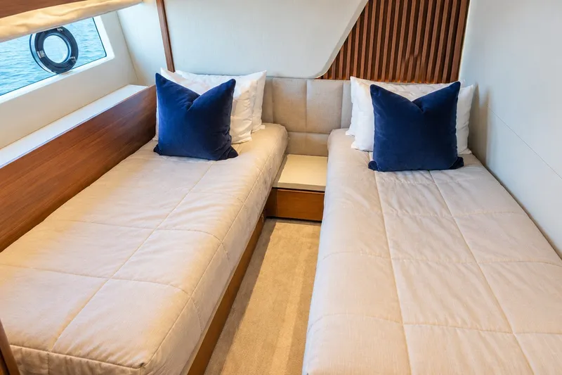 Slide: The Image of Luxurious twin cabin interior on 2021 Princess Y85 yacht with blue accent pillows. - 57