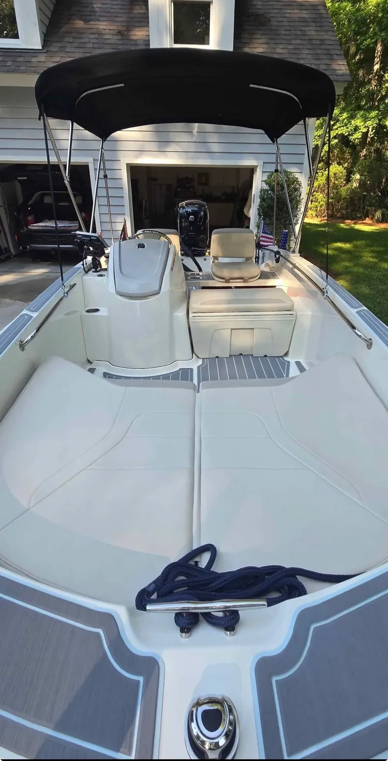 Slide: The Image of Boston Whaler 160 Super Sport 2021 with sunshade, beige upholstery, and motor in the background. - 6