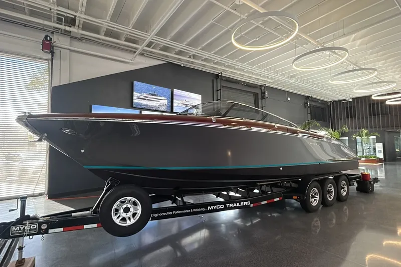 The Image of 2025 Riva 33' Aquariva Special boat on trailer in modern showroom. - 0