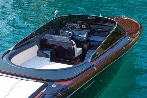 Slide: The Image of 2025 Riva 33' Aquariva Special luxury boat on clear blue water. - 2