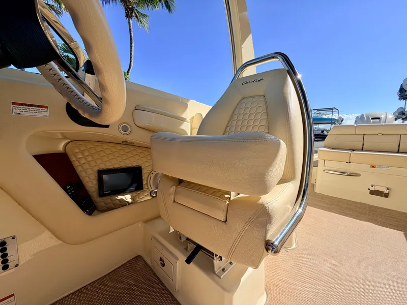 Slide: The Image of Interior of a 2019 Chris-Craft Launch 28 GT OB with beige upholstered seat and steering wheel. - 43