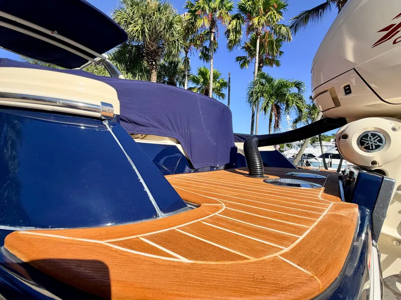 Slide: The Image of The image shows the stern of a 2019 Chris-Craft Launch 28 GT OB with a teak deck. - 23
