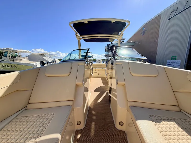 Slide: The Image of The image shows the interior of a 2019 Chris-Craft Launch 28 GT OB with beige seating. - 34