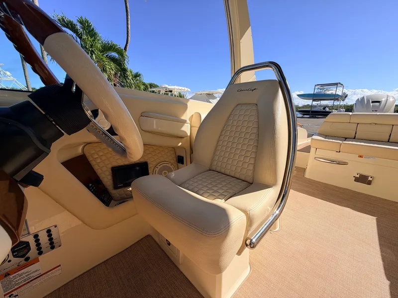 Slide: The Image of Interior of a 2019 Chris-Craft Launch 28 GT OB with beige upholstered seat and steering wheel. - 46