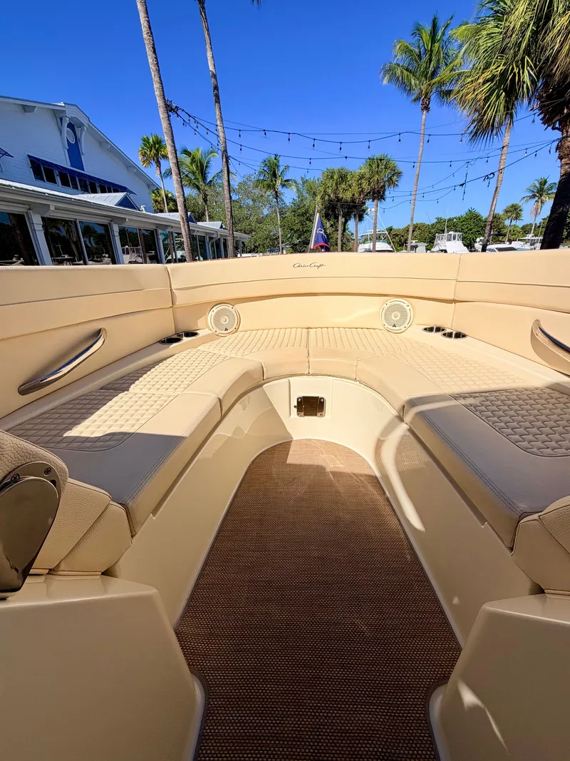 Slide: The Image of Interior view of a 2019 Chris-Craft Launch 28 GT OB with elegant seating and palm trees in the background. - 30
