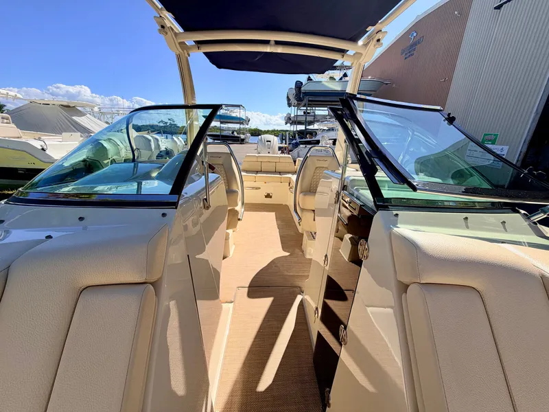 Slide: The Image of Interior view of a 2019 Chris-Craft Launch 28 GT OB with beige seats and glass windows. - 40