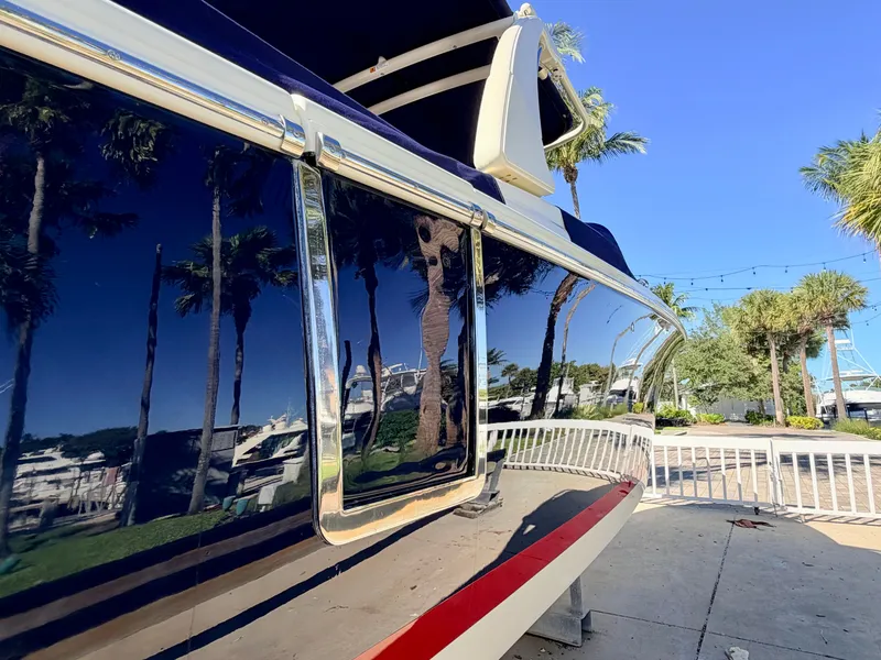 Slide: The Image of Side view of a 2019 Chris-Craft Launch 28 GT OB, glossy finish with palm trees in the background. - 21