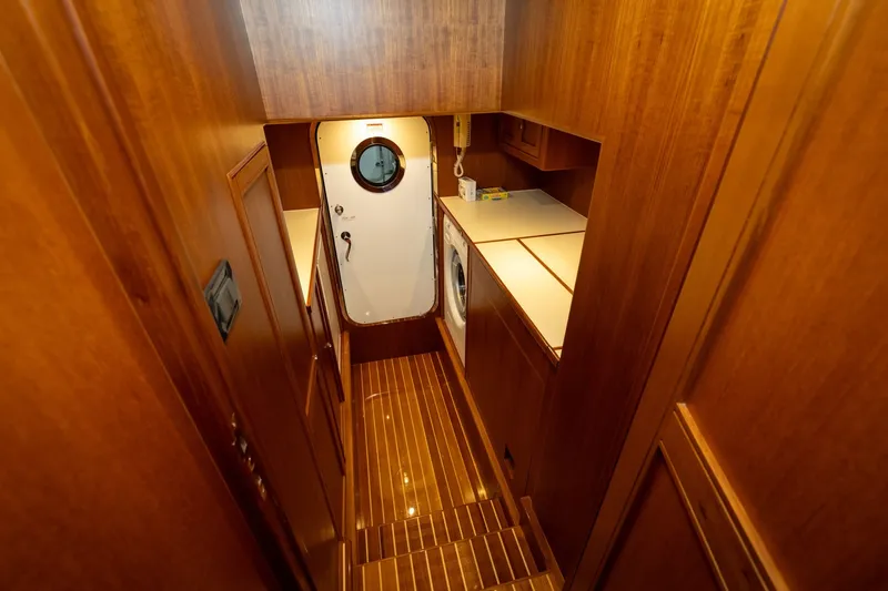 Slide: The Image of Laundry area on 2019 Marlow Explorer 49E yacht with wooden interior and washing machine. - 68