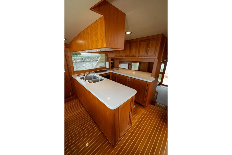 Slide: The Image of Luxurious kitchen interior of 2019 Marlow Explorer 49E yacht with wooden cabinetry and countertops. - 40