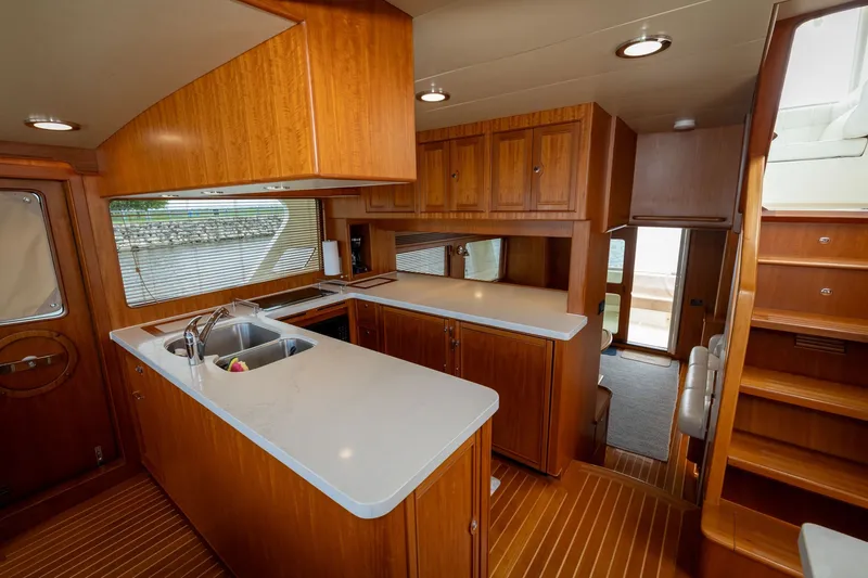 Slide: The Image of Luxurious 2019 Marlow Explorer 49E yacht interior with modern kitchen and wooden cabinetry. - 41