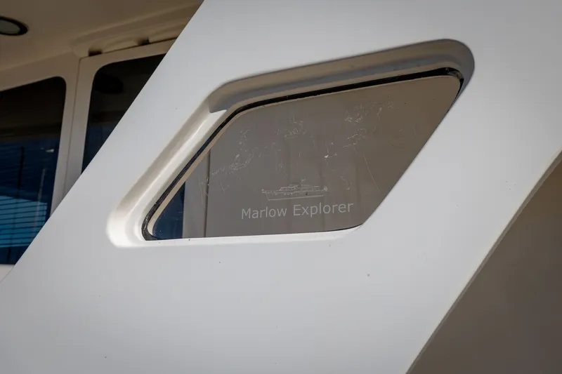 Slide: The Image of Close-up of 2019 Marlow Explorer 49E yacht window with logo. - 24