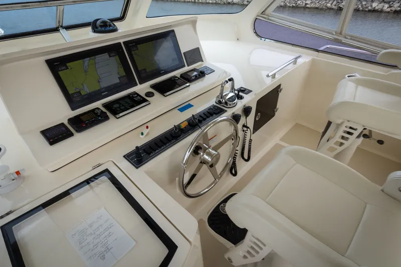 Slide: The Image of Cockpit of 2019 Marlow Explorer 49E yacht with navigation screens and steering wheel. - 81