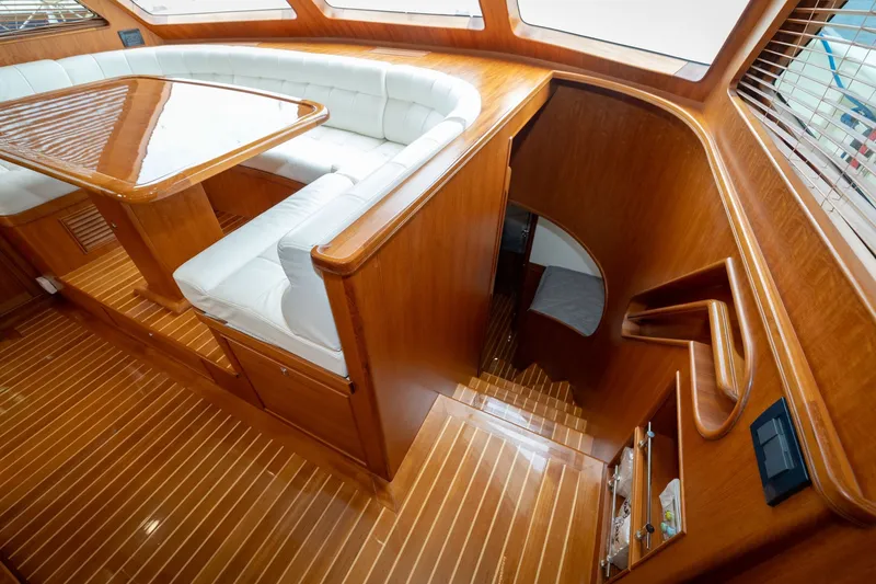 Slide: The Image of Luxurious interior of 2019 Marlow Explorer 49E yacht with wooden finishes and white seating. - 52