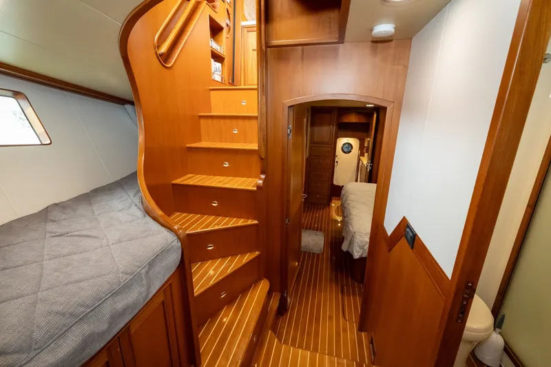Slide: The Image of Luxurious interior of 2019 Marlow Explorer 49E yacht with wooden stairs and cozy cabin. - 53