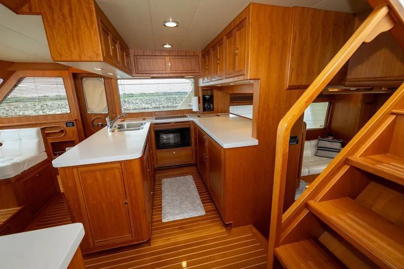 Slide: The Image of Luxurious 2019 Marlow Explorer 49E yacht interior with modern kitchen and wooden finishes. - 44