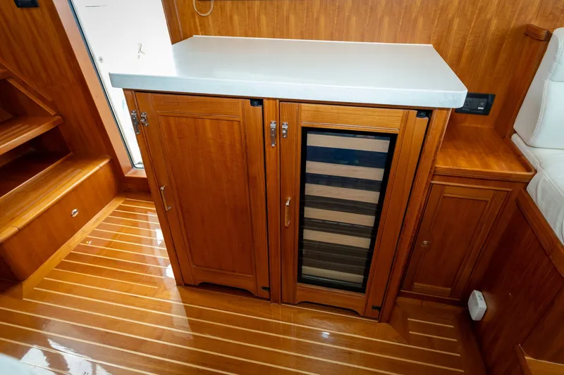Slide: The Image of Wooden cabinetry and wine cooler in 2019 Marlow Explorer 49E yacht interior. - 48