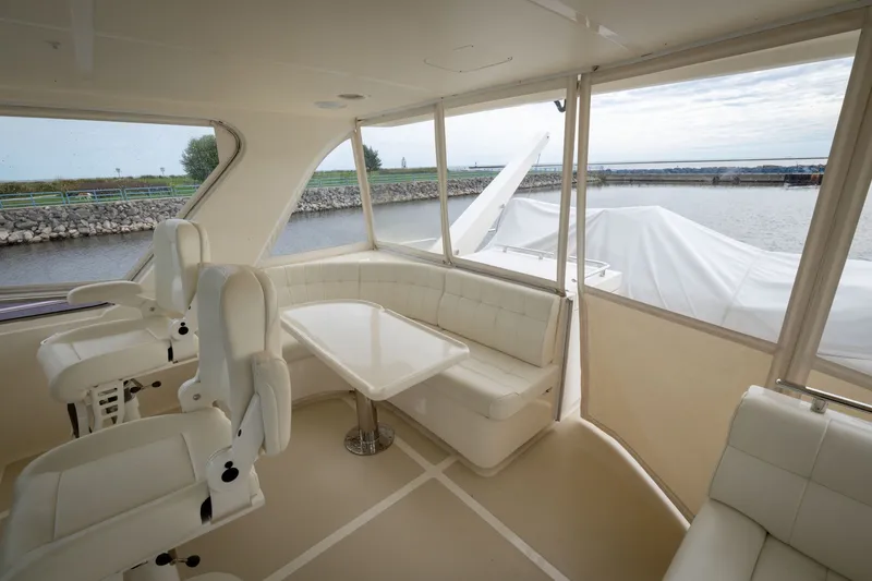 Slide: The Image of Luxurious interior of 2019 Marlow Explorer 49E yacht with white seating and scenic water view. - 78