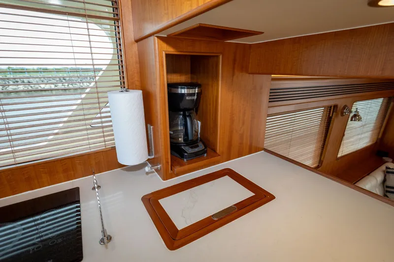 Slide: The Image of Modern kitchen area in 2019 Marlow Explorer 49E yacht with coffee maker and paper towel holder. - 46