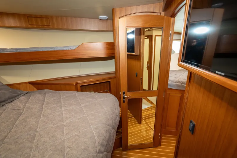Slide: The Image of Interior of 2019 Marlow Explorer 49E yacht with wooden finishes and cozy bedding. - 64