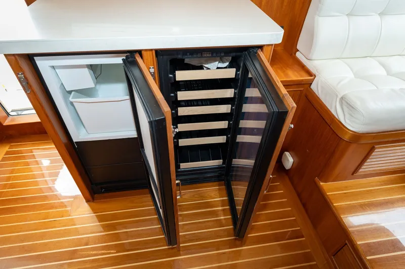 Slide: The Image of Open fridge and wine cooler on 2019 Marlow Explorer 49E yacht with wooden flooring. - 49