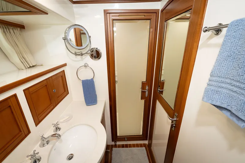 Slide: The Image of Luxurious bathroom interior of 2019 Marlow Explorer 49E yacht with wood accents and modern fixtures. - 59