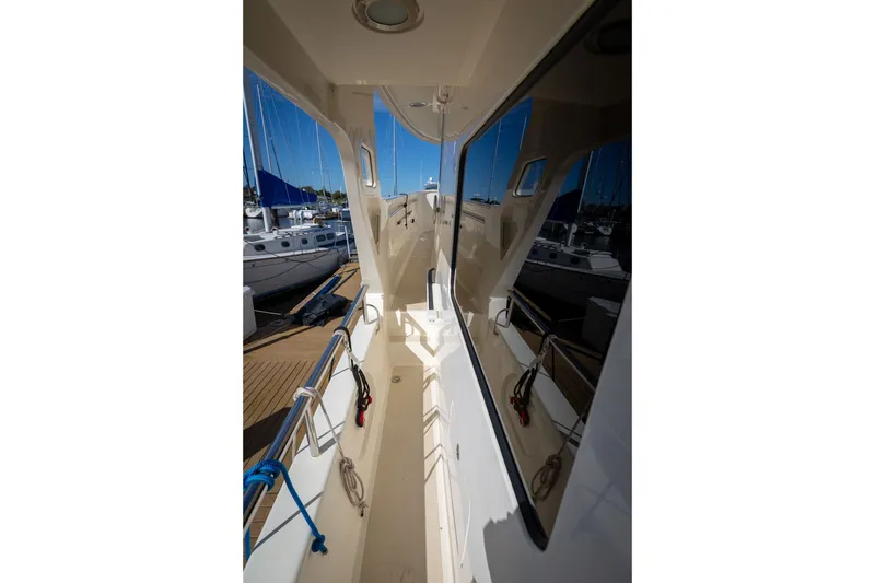 Slide: The Image of Side deck view of 2019 Marlow Explorer 49E yacht at marina. - 26