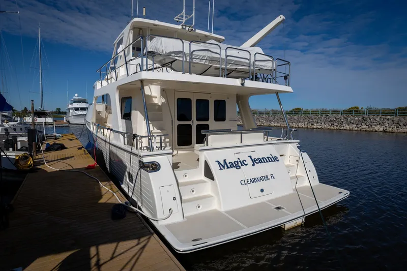 Slide: The Image of 2019 Marlow Explorer 49E yacht docked, named "Magic Jeannie," in Clearwater, Florida marina. - 14