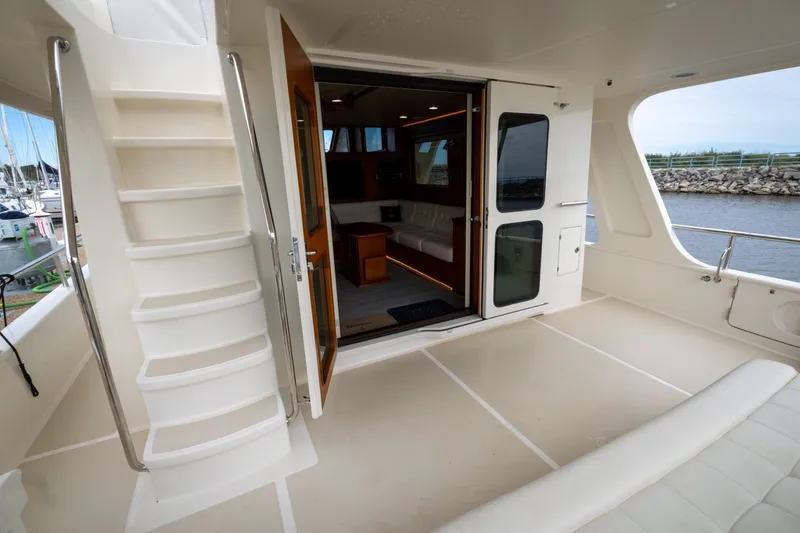 Slide: The Image of 2019 Marlow Explorer 49E yacht interior with open door and staircase view. - 28