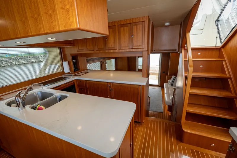 Slide: The Image of Luxurious interior of 2019 Marlow Explorer 49E yacht with modern kitchen and wooden finishes. - 42