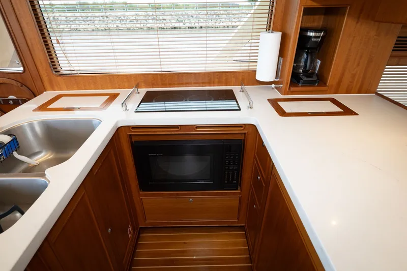 Slide: The Image of Modern kitchen in 2019 Marlow Explorer 49E yacht with stove, microwave, and sink. - 45