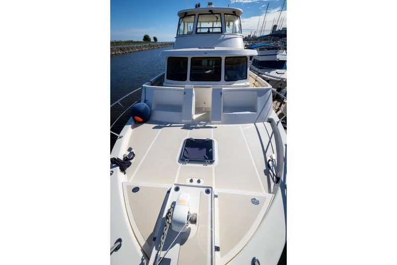 Slide: The Image of 2019 Marlow Explorer 49E yacht docked, showcasing spacious deck and sleek design. - 18