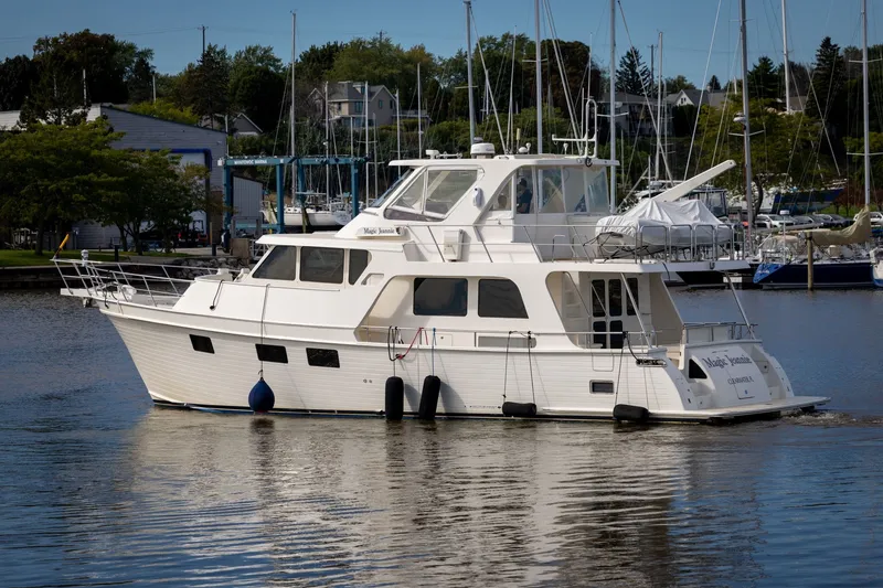 Slide: The Image of 2019 Marlow Explorer 49E yacht docked in a marina with sailboats in the background. - 7