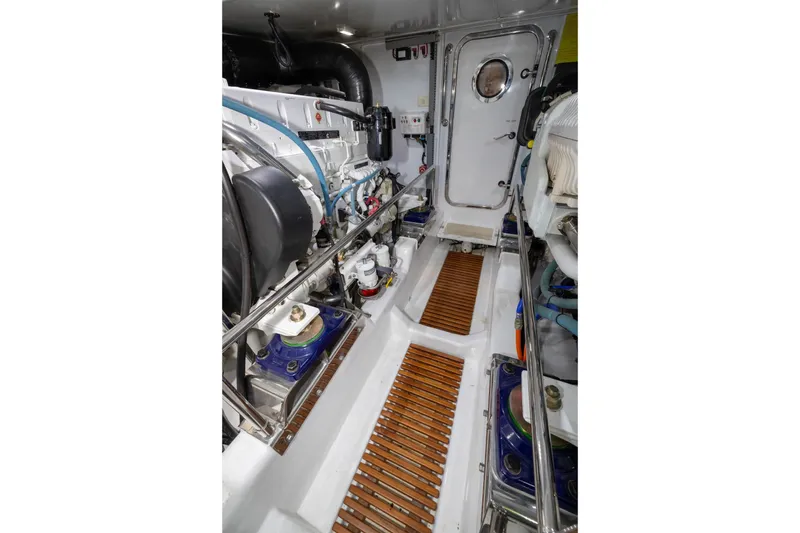 Slide: The Image of Engine room of 2019 Marlow Explorer 49E yacht, featuring mechanical components and access door. - 72