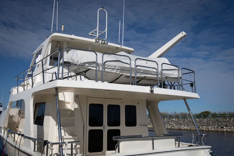 Slide: The Image of 2019 Marlow Explorer 49E yacht docked, showcasing upper deck and sleek design. - 17